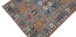 Backside of handmade New Kazak rug showing knot structure and weave density