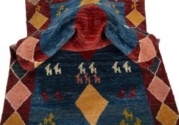 Corner detail of 2000s Persian Gabbeh rug showing border pattern and Wool pile