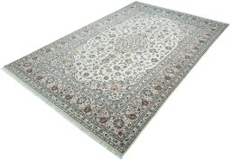 Corner detail of 2000s Kashan rug showing border pattern and Wool pile