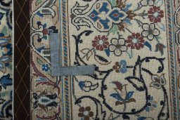 Backside of handmade 2000s Nain rug showing knot structure and weave density