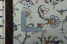 Backside of handmade New Kashan rug showing knot structure and weave density