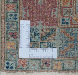 Corner detail of New Kazak rug showing border pattern and Wool pile