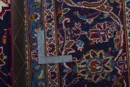 Backside of handmade 2000s Kashan rug showing knot structure and weave density