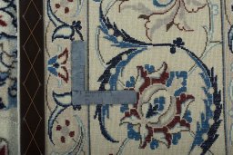 Backside of handmade 2000s Nain rug showing knot structure and weave density