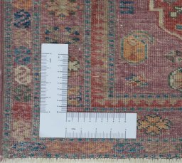 Corner detail of New Kazak rug showing border pattern and Wool pile