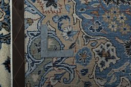 Backside of handmade 2000s Kashan rug showing knot structure and weave density