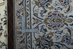 Backside of handmade 2000s Kashan rug showing knot structure and weave density