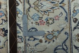 Backside of handmade 2000s Kashan rug showing knot structure and weave density
