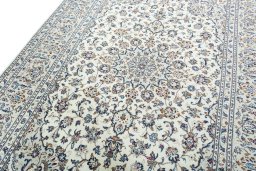 Backside of handmade 2000s Kashan rug showing knot structure and weave density