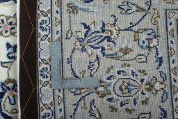 Backside of handmade 2000s Kashan rug showing knot structure and weave density