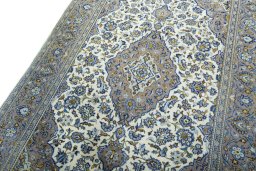 Backside of handmade 2000s Kashan rug showing knot structure and weave density